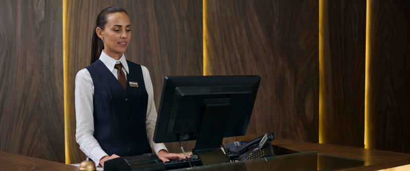 Hospitality staff member operating the reception desk in a hotel – MSS Electronics