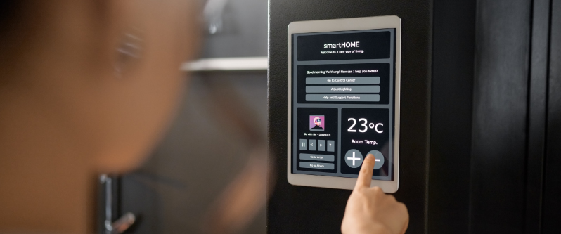 Wall-mounted smart home control panel displaying temperature settings and HVAC automation through KNX and BMS integration.